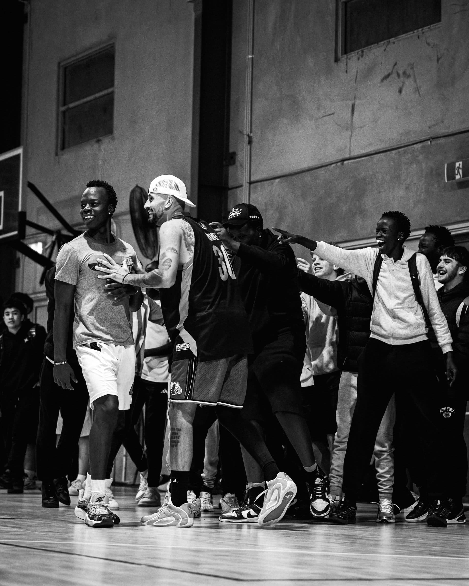Brand activation moment, athlete with crowd on court.