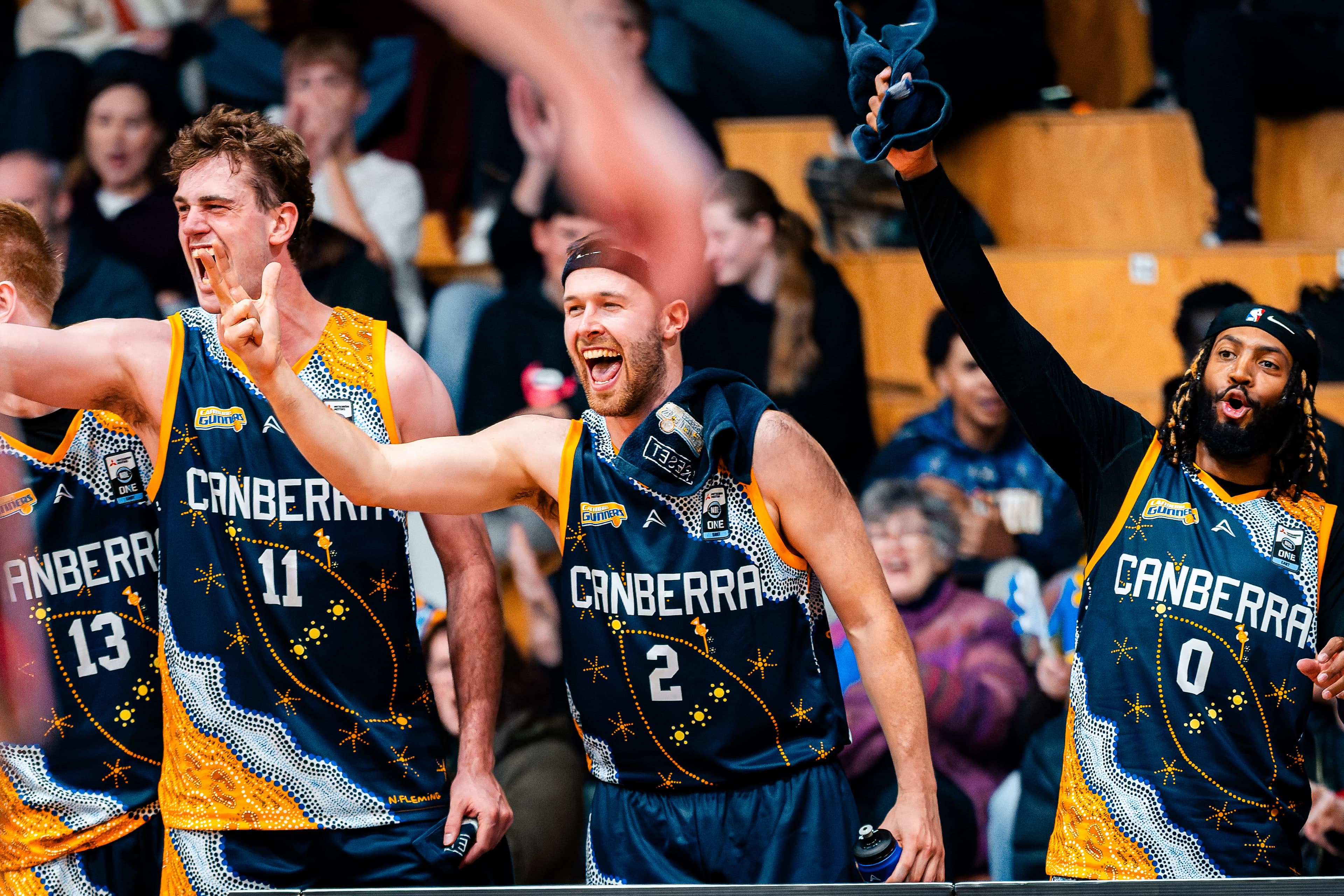 The Canberra Gunners bench erupts mid game in their Indigenous round jerseys