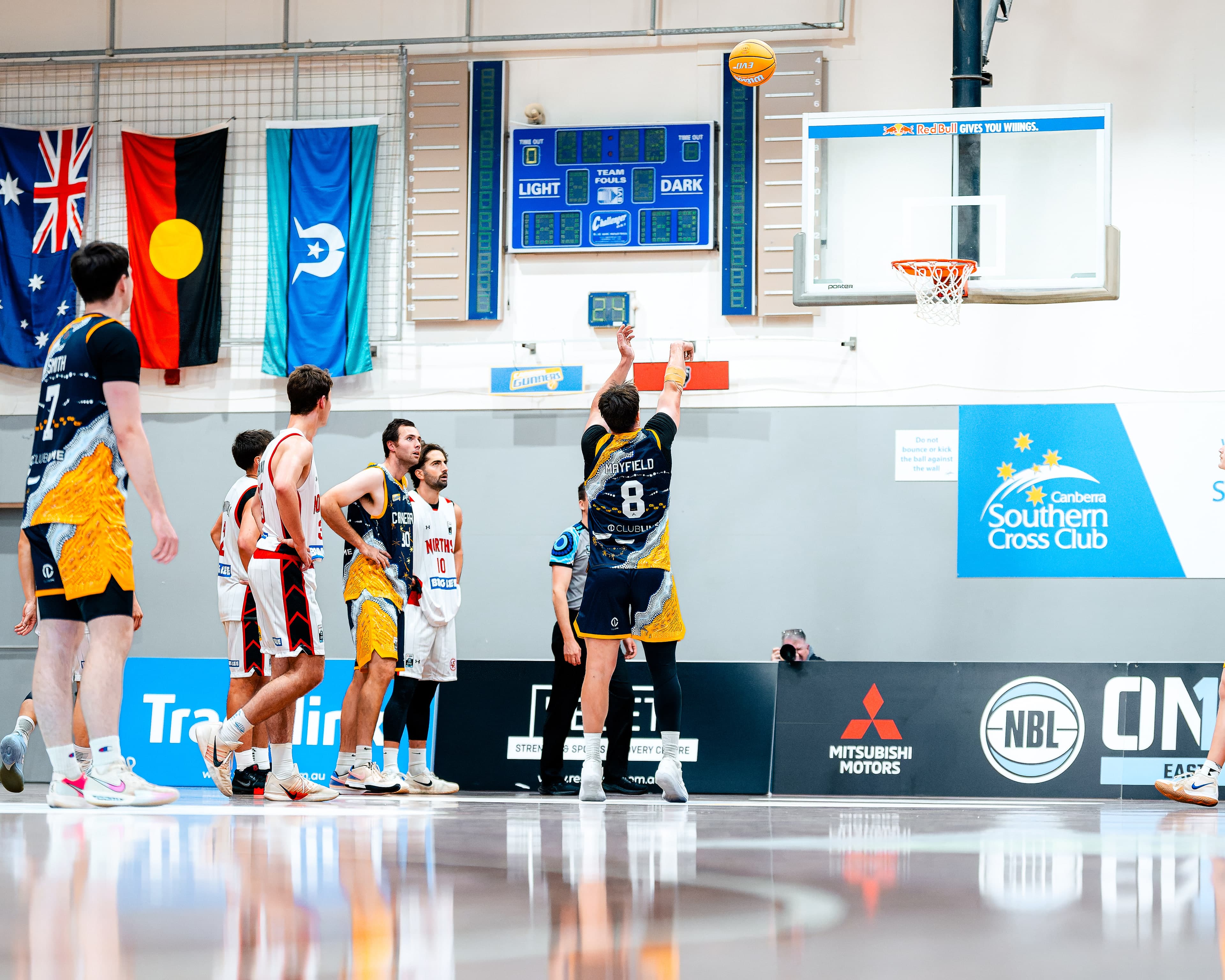 A free throw beneath the Australian, Aboriginal and Torres Strait Islander flags at an NBL1 East game