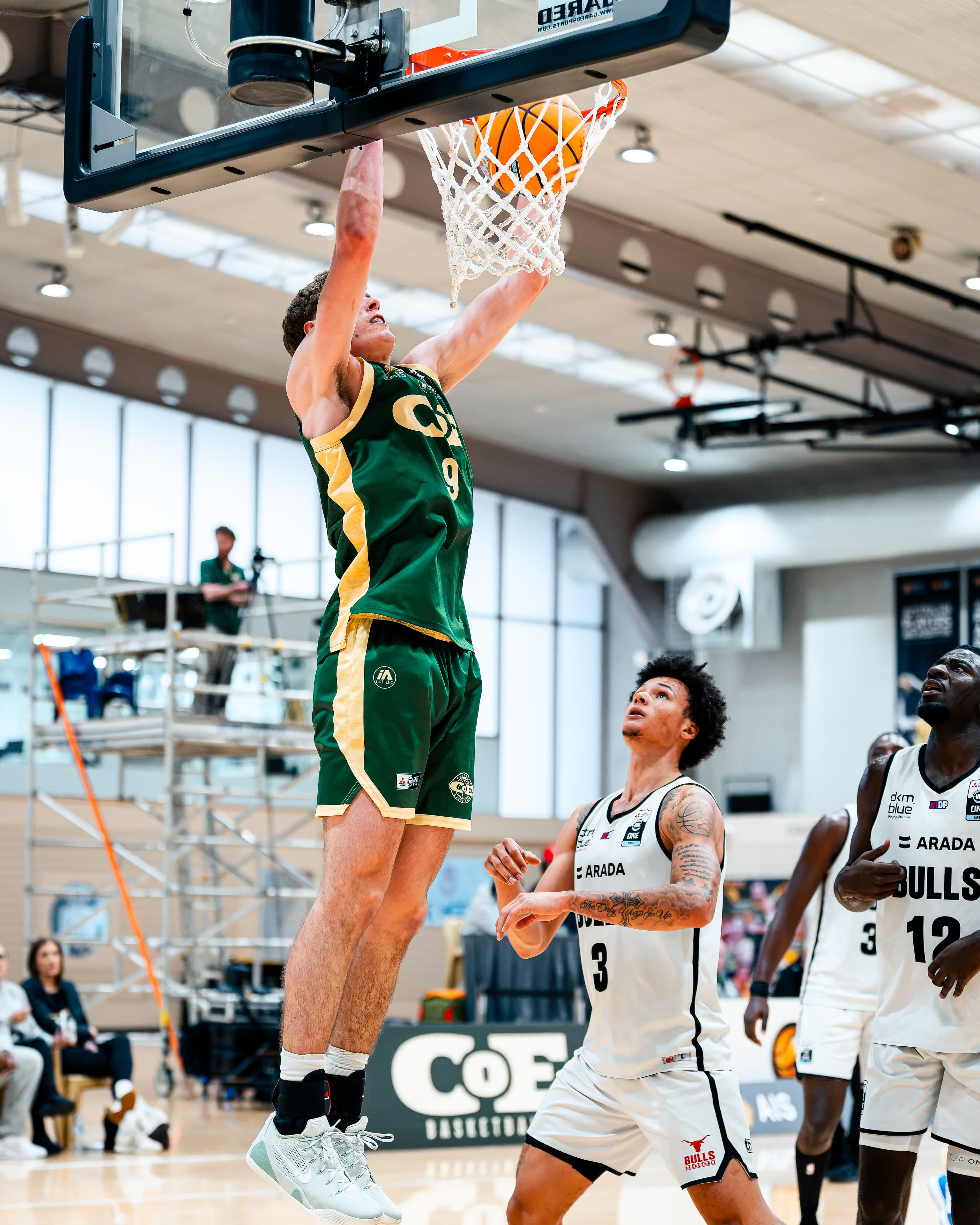 A COE player finishes at the rim against the Bulls