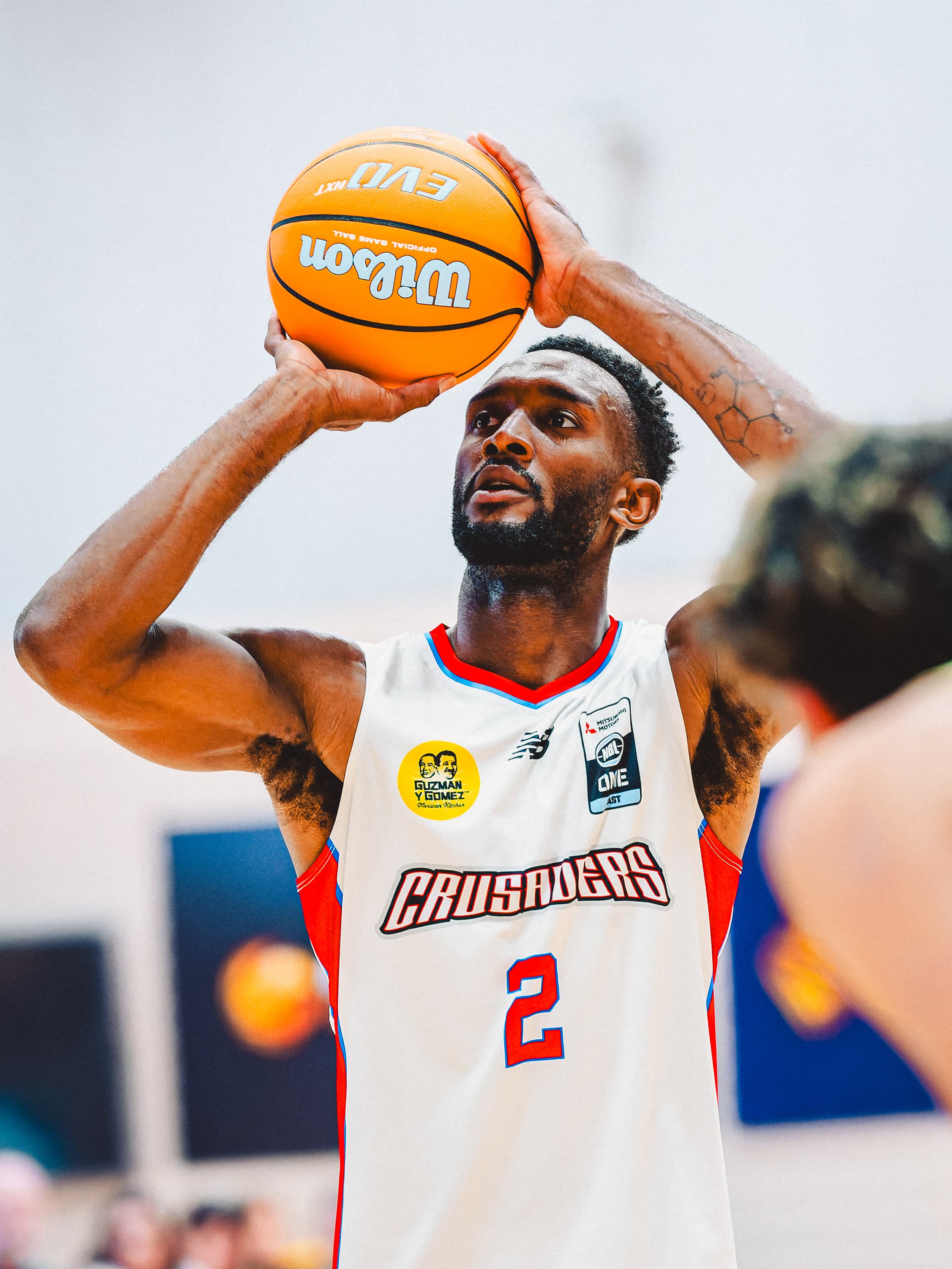 A Central Coast Crusaders guard lines up a free throw, ball level with his eyes