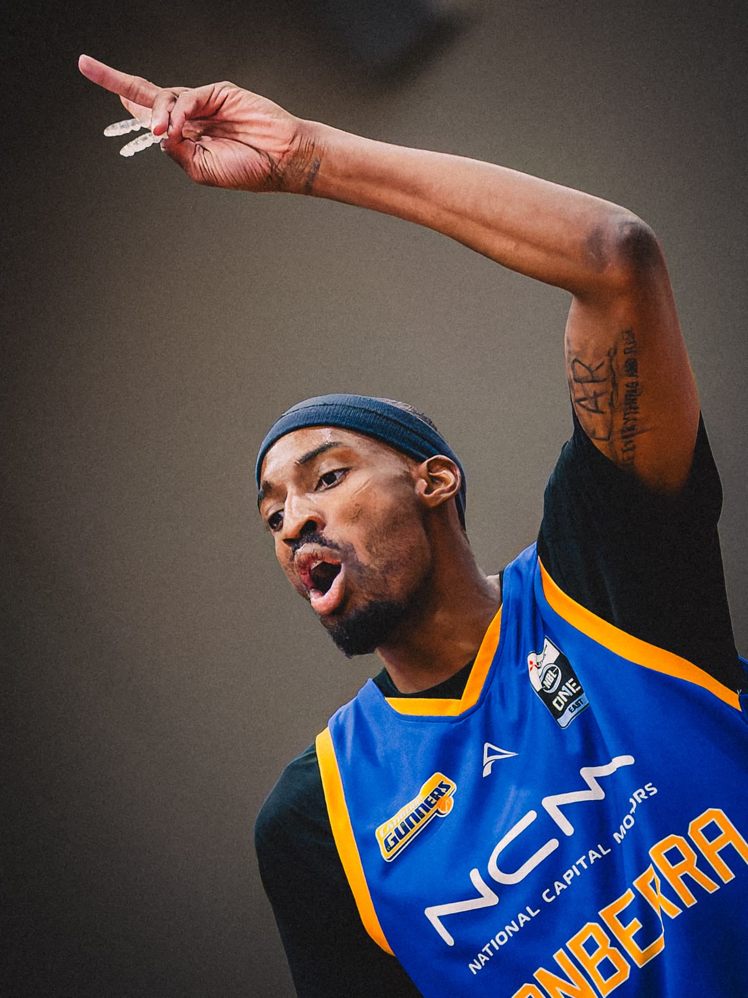 A Canberra Gunners player points down the floor after a score