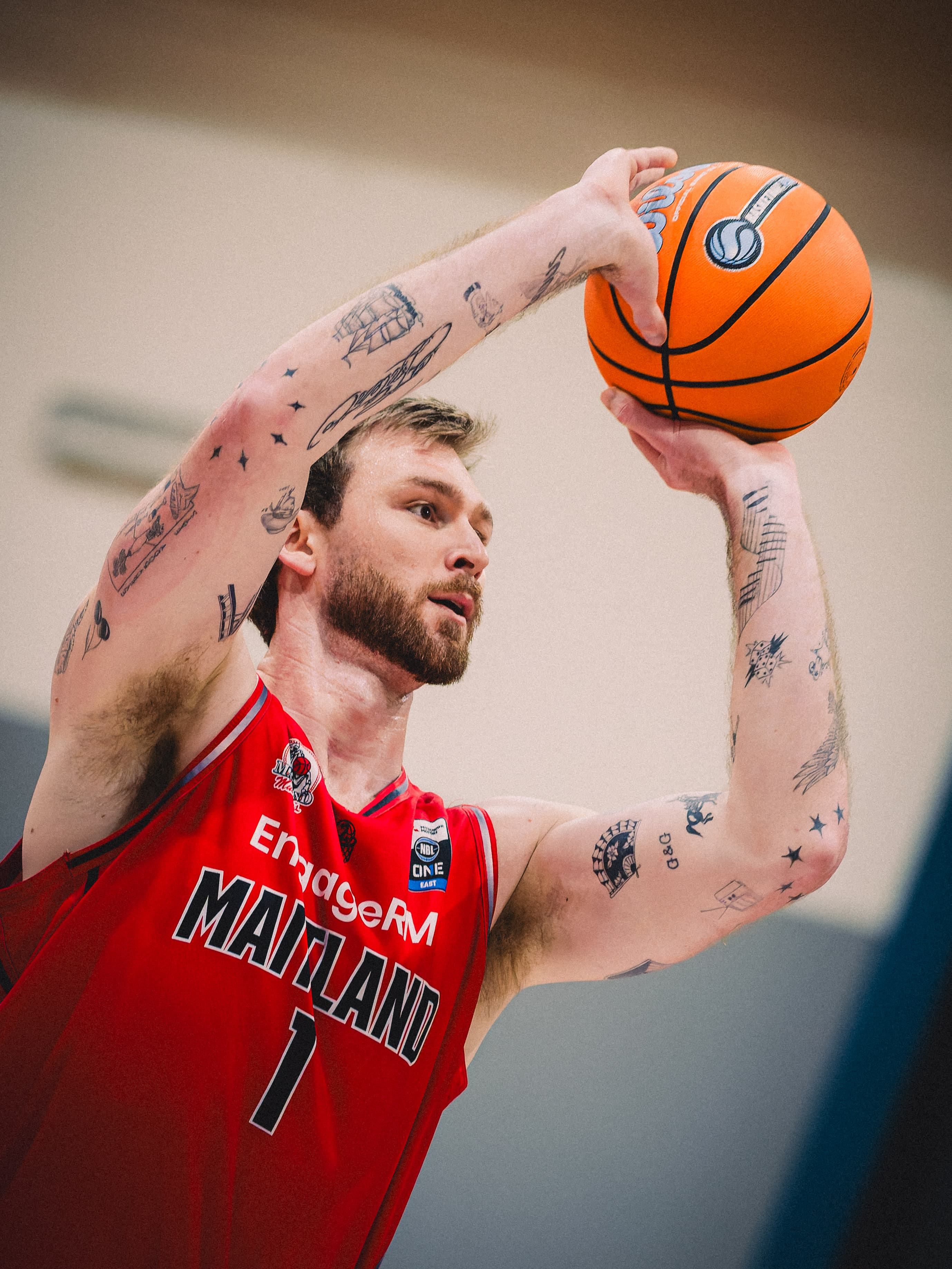 A Maitland Mustangs forward palms the ball above his head before he shoots