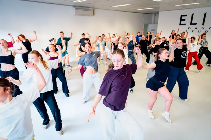 Dancers moving together across the floor at Elite Dance Studios