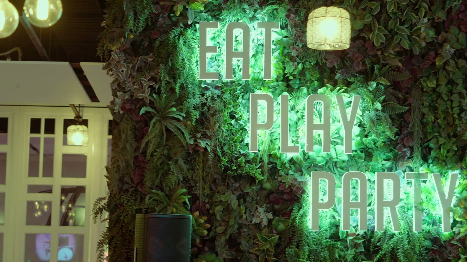 Neon Eat Play Party sign at the venue