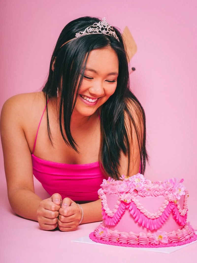 Looking down at the heart-shaped cake while holding a knife and fork