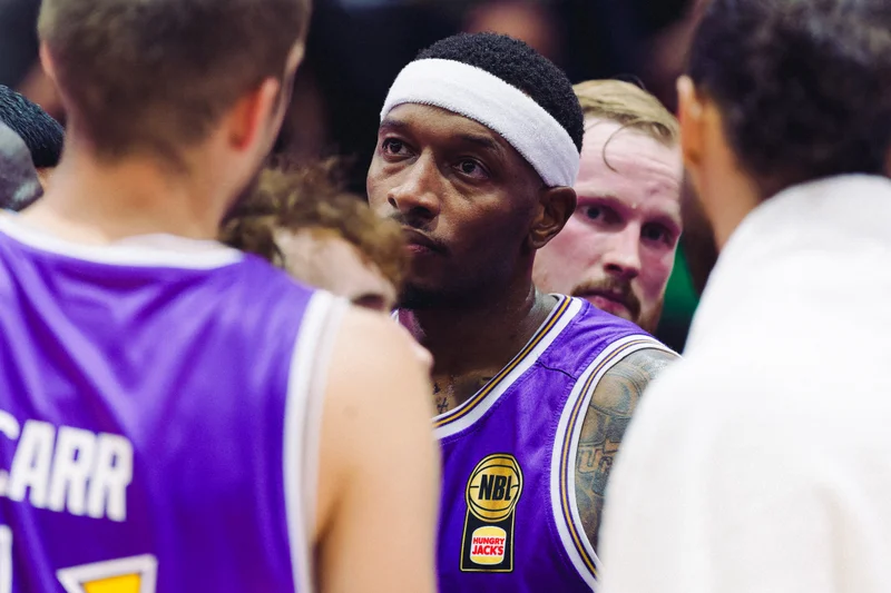 Sydney Kings player listening in a team huddle